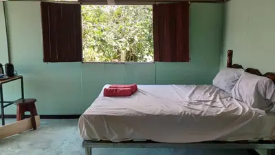 a bed sitting in a room with a window at Árbol de mayo in Jiménez