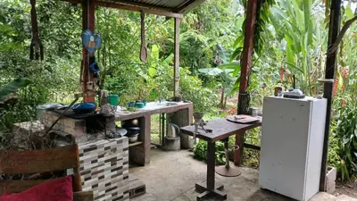 an outdoor kitchen with a table and a refrigerator at Árbol de mayo in Jiménez