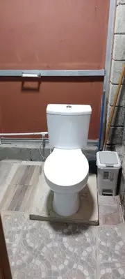 a white toilet sitting in front of a building at Árbol de mayo in Guápiles