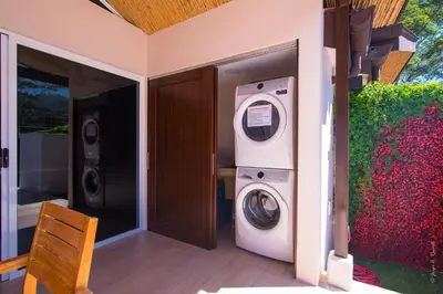 a washing machine and a washer and dryer in a house at Pop House with private pool at Ciudad del Mar in Jaco in Jacó