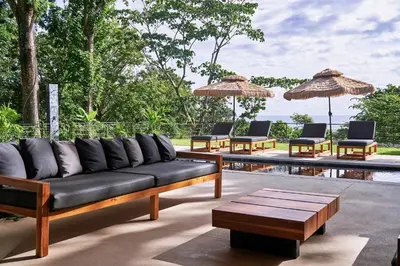 a living room with a couch and chairs and a pool at Villa Alba 4ensuite rooms ocean view Malpais in Mal País