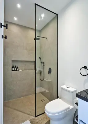 a shower stall in a bathroom with a toilet at Villa Alba 4ensuite rooms ocean view Malpais in Mal País