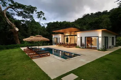 a villa with a swimming pool and a house at Villa Alba 4ensuite rooms ocean view Malpais in Mal País