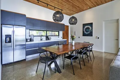 a kitchen with a large wooden table and chairs at Villa Alba 4ensuite rooms ocean view Malpais in Mal País