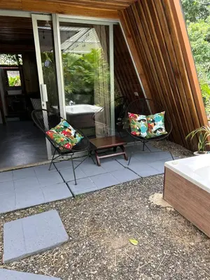 a patio with two chairs and a table on a house at IkI Tiny Villa in Fortuna