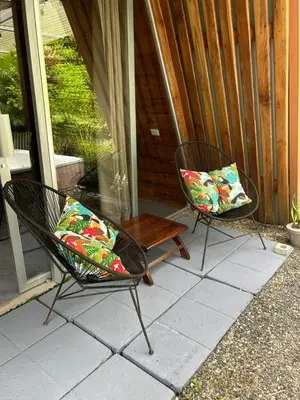 two chairs with pillows sitting on a patio at IkI Tiny Villa in Fortuna