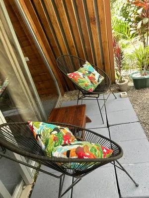 two chairs with pillows sitting on a patio at IkI Tiny Villa in Fortuna