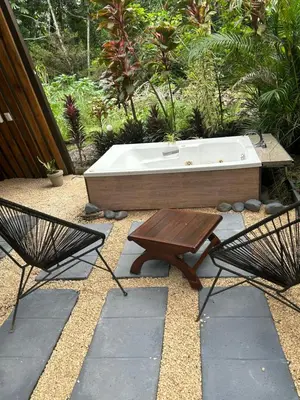 a hot tub and a table and two chairs at IkI Tiny Villa in Fortuna