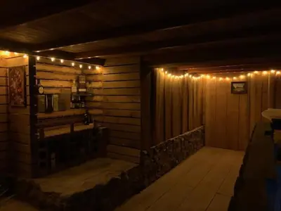 a wooden room with lights on a wall at Cabaña de Montaña in Cartago