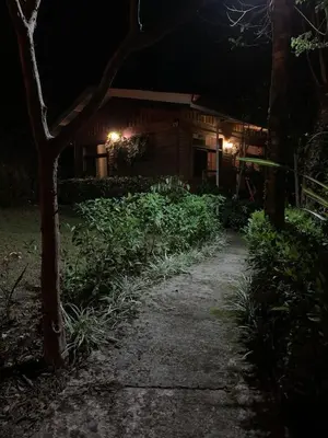 a walkway in front of a house at night at Cabaña de Montaña in Cartago