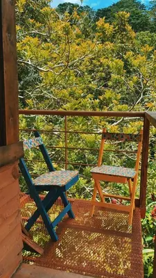 a blue chair sitting on the porch of a cabin at Cabaña de Montaña in Cartago