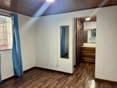 an empty room with a mirror and a bathroom at Carolina Hostel in San José