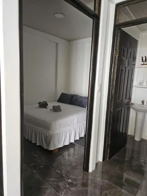 a bedroom with a bed and a mirror at Monkey House in Tortuguero