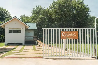 a sign on a fence in front of a building at Cedrela Beach Villas in Uvita