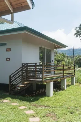 a house with a large deck on the side of it at Cedrela Beach Villas in Uvita