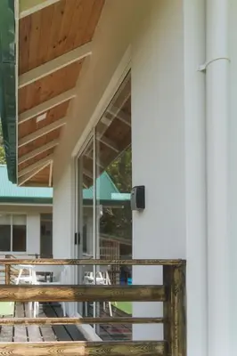 an external view of a building with a balcony with tables at Cedrela Beach Villas in Uvita