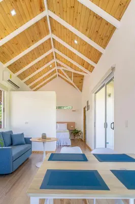 a living room with a blue couch and a table at Cedrela Beach Villas in Uvita
