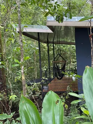 a tree house in the forest with a swing at Deer Houses Cabuya in Cabuya