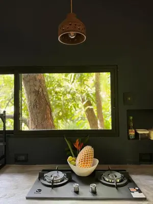 a kitchen with a bowl of fruit on a stove at Deer Houses Cabuya in Cabuya