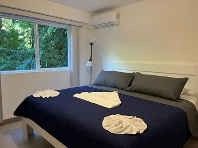 a bedroom with a bed with two towels on it at Punta Esmeralda, Puntarenas Great Apartment in Quebrada Ganado
