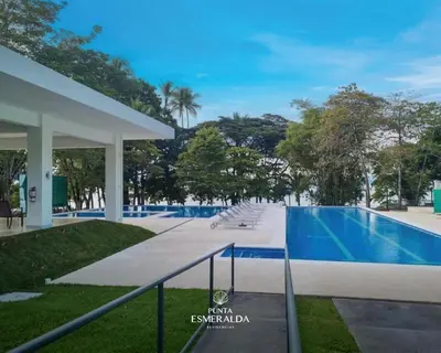 a swimming pool with lounge chairs next to a resort at Punta Esmeralda, Puntarenas Great Apartment in Quebrada Ganado
