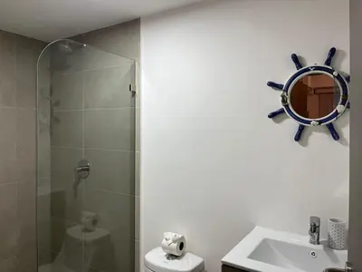 a bathroom with a shower and a sink and a mirror at Punta Esmeralda, Puntarenas Great Apartment in Quebrada Ganado