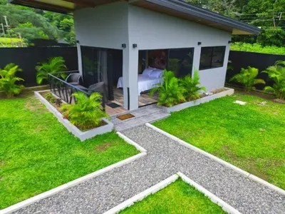 a garden with a house with a lawn at Casitas del Arenal in Fortuna