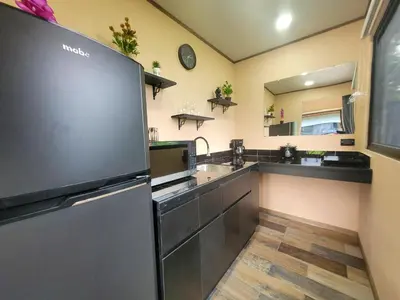 a kitchen with a refrigerator and a sink at Casitas del Arenal in Fortuna