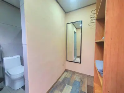 a bathroom with a toilet and a mirror at Casitas del Arenal in Fortuna