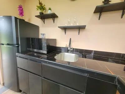 a kitchen with a sink and a refrigerator at Casitas del Arenal in Fortuna