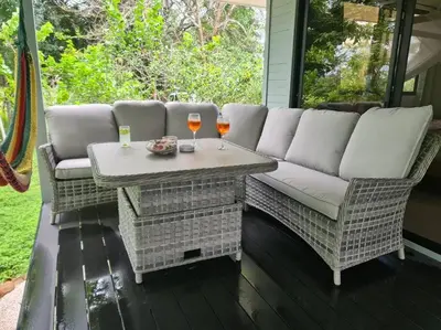a patio with a couch and two glasses of wine at Casa Lupa in San Rafael