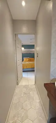 a hallway with a door leading to a bedroom at Pipas Apartment in Tamarindo