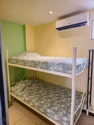 two bunk beds in a room with a heater at Pipas Apartment in Tamarindo