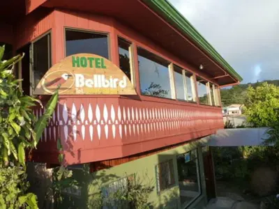 a hotel building with a reflection in the water at Hotel Bell Bird in Monteverde Costa Rica