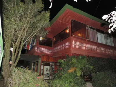 a large red building with a lot of windows at Hotel Bell Bird in Monteverde Costa Rica