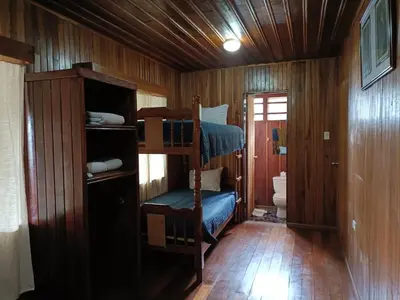 a room with two bunk beds and a toilet at Hotel Bell Bird in Monteverde Costa Rica
