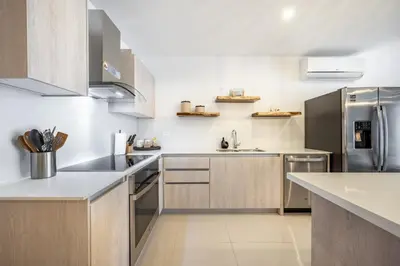 a kitchen with white counters and stainless steel appliances at La Vista B8 in Tamarindo
