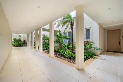 an empty hallway with palm trees in a building at La Vista B8 in Tamarindo
