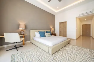 a bedroom with a bed and a desk and a chair at La Vista B8 in Tamarindo