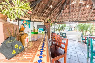 a restaurant with a long table and chairs at Villa Margarita in Alajuela City