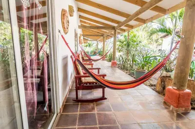 a hammock on the porch of a house at Villa Margarita in Alajuela City