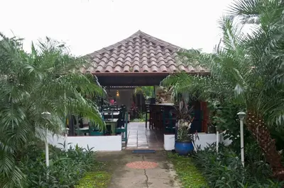 a pavilion with a table and palm trees at Villa Margarita in Alajuela City