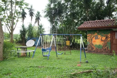 a playground with a swing set in a yard at Villa Margarita in Alajuela City