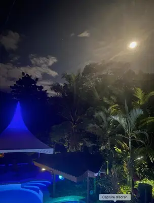 a view of a resort at night with the moon at Casa Aba Matapalo in Matapalo