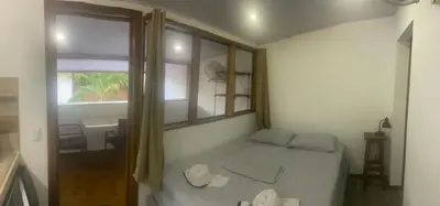a small bedroom with a bed and a window at Casa Aba Matapalo in Matapalo