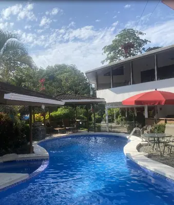 a swimming pool in front of a building at Casa Aba Matapalo in Matapalo