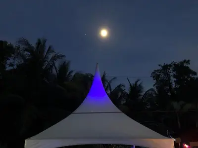 a white tent with a moon in the sky at Casa Aba Matapalo in Matapalo