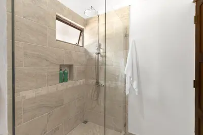 a bathroom with a shower with a glass door at Angels Sol Villa Hermosa 2b2b European Villa in Playa Hermosa