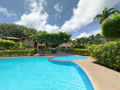 a swimming pool at a resort with trees at Angels Sol Villa Hermosa 2b2b European Villa in Playa Hermosa