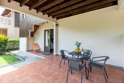 a patio with a black table and chairs at Angels Sol Villa Hermosa 2b2b European Villa in Playa Hermosa
